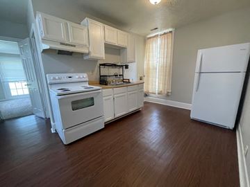 New Albany apartment for rent - A kitchen with white appliances and wooden floors.