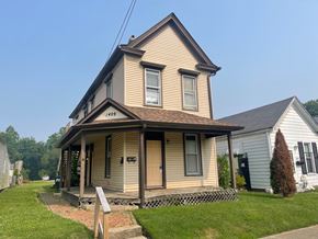 New Albany apartment for rent - A two-story house with a porch and a mailbox on the front door.