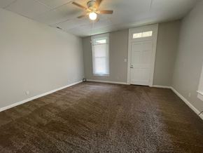New Albany apartment for rent - A room with a carpeted floor and a ceiling fan.
