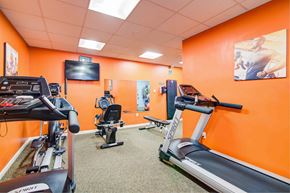 Marlton apartment for rent - a gym with various exercise machines and a television