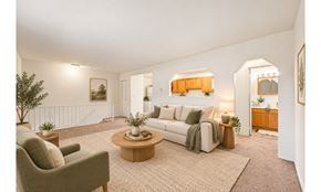 Marlton apartment for rent - A living room with a couch, armchair, and coffee table.