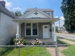 Louisville house for rent - a house with a white door and a chain link fence