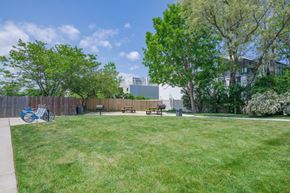 Long Branch apartment for rent - a park with grass and benches in front of a building