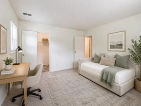 Freehold apartment for rent - A bedroom with a bed, desk, and chair.