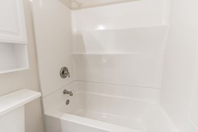 Louisville house for rent - a white bathroom with a tub and a sink