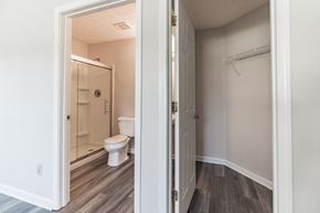 Louisville house for rent - an open door leading to a bathroom with a toilet and shower