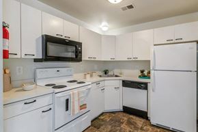 Pleasantville apartment for rent - a kitchen with white appliances and white cabinets