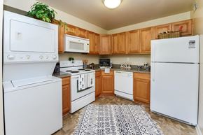 Eastampton apartment for rent - a kitchen with white appliances and wooden cabinets