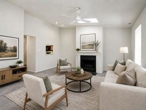 Clementon apartment for rent - A living room with a fireplace, two chairs, and a couch.