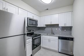 Clementon apartment for rent - a kitchen with stainless steel appliances and white cabinets