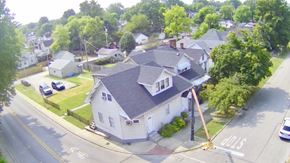 New Albany apartment for rent - A house with a grey roof is surrounded by green trees.