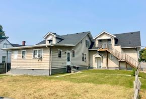 New Albany apartment for rent - A house with a grey siding and a brown roof.