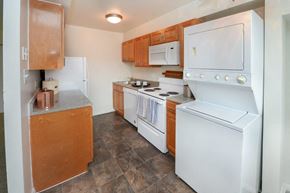 Somerdale apartment for rent - a kitchen with white appliances and wooden cabinets