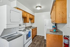 Somerdale apartment for rent - A kitchen with white appliances and wooden cabinets.