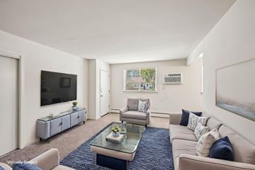 Somerdale apartment for rent - A living room with a glass coffee table and a television on the wall.