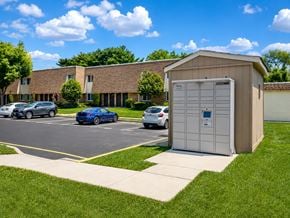 West Deptford apartment for rent - A parking lot with cars and a building in the background.