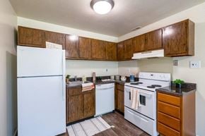West Deptford apartment for rent - a kitchen with white appliances and wooden cabinets