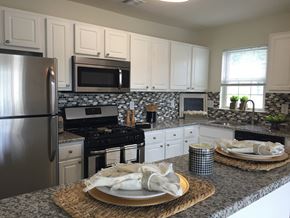 Marlton apartment for rent - a kitchen with white cabinets and granite counter tops and stainless steel appliances