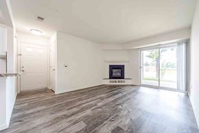 King Of Prussia apartment for rent - A spacious room with a fireplace and sliding glass doors.