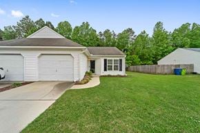 Havelock house for rent - A house with a white garage door and a small porch.