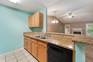 Havelock house for rent - A kitchen with a granite countertop and a black dishwasher.