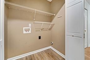 Havelock house for rent - Empty walk-in closet with white shelves and a white door.