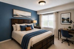 Randallstown apartment for rent - A bedroom with a large bed and a desk with a chair.