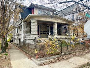Louisville apartment for rent - A house with a black fence and a green lawn.