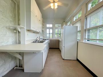 Louisville apartment for rent - A kitchen with white appliances and a large island.
