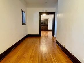 Louisville apartment for rent - A hallway with wooden floors and white walls.