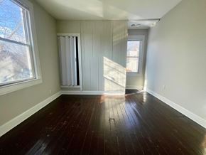 Louisville apartment for rent - A room with wooden floors and a window.