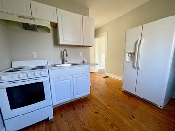Louisville apartment for rent - A kitchen with a white stove and refrigerator.