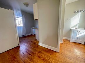 Louisville apartment for rent - A room with wooden floors and white walls.