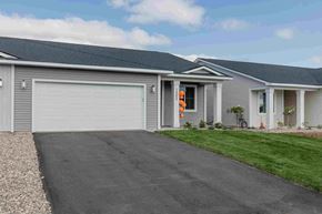 New Richmond house for rent - a gray house with a white garage door and a driveway