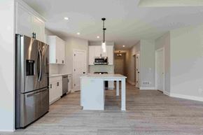 New Richmond house for rent - a kitchen with a white island and stainless steel appliances