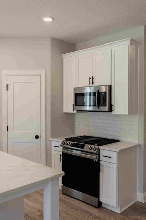 New Richmond house for rent - a white kitchen with a stove and a microwave