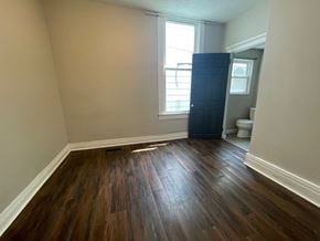 Jeffersonville house for rent - A room with wooden flooring and a window.