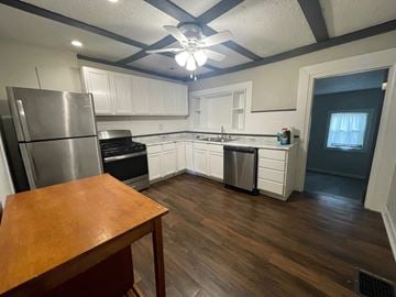 Jeffersonville house for rent - A kitchen with a wooden table and a refrigerator.