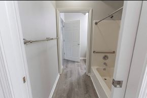 New Albany apartment for rent - a bathroom with a shower and a bath tub and a door
