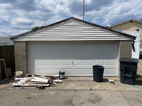 New Albany house for rent - a new garage door is being installed on a house