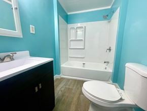 New Albany house for rent - a bathroom with a toilet and a tub and a sink