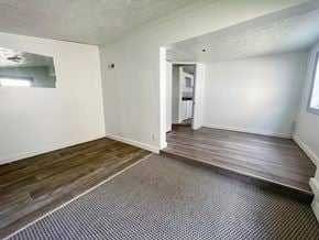 New Albany house for rent - an empty living room with wood flooring and white walls