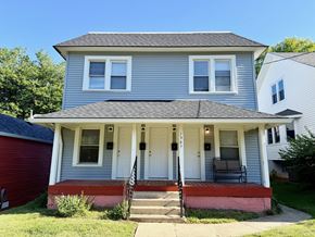 Louisville apartment for rent - A two-story house with a red garage door and a white front door.