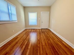 Louisville apartment for rent - A room with wooden flooring and a white door.