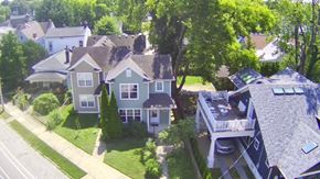 Louisville house for rent - A bird's eye view of a residential area with houses and trees.