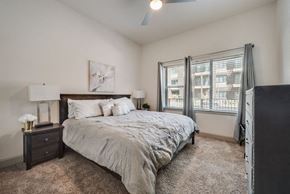 Plano house for rent - a bedroom with a bed and two windows