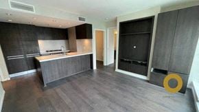 Vancouver house for rent - A modern kitchen with dark wood floors and a black oven.