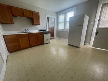 New Albany apartment for rent - an empty kitchen with a refrigerator and a sink