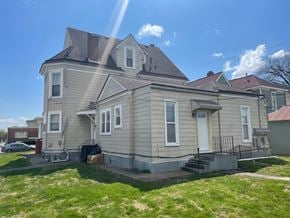 New Albany apartment for rent - a tan house with a gray roof and a yard
