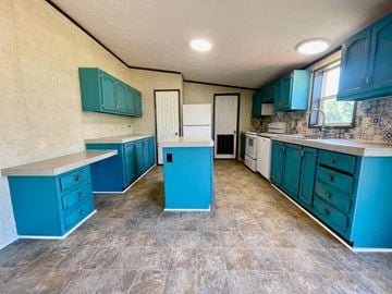 Charlestown house for rent - A kitchen with blue cabinets and a tile floor.